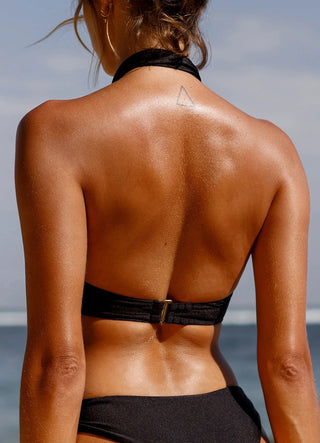 Model wearing Anjuum Tiger Top 2-in-1 Black on the beach.